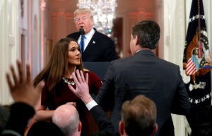 A White House staff member steps in to try to take the microphone away from CNN's Jim Acosta as he questions U.S. President Donald Trump during a news conference following Tuesday's midterm U.S. congressional elections at the White House in Washington, U.S., November 7, 2018. REUTERS/Kevin Lamarque     TPX IMAGES OF THE DAY